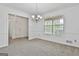 Well-lit dining room featuring large windows and stylish chandelier at 100 Walnut Ct, Stockbridge, GA 30281