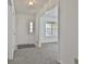 Bright foyer with fresh paint, a large window, and modern gray carpet throughout at 100 Walnut Ct, Stockbridge, GA 30281