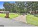 Lovely front yard with green grass, white fence and long concrete driveway to home at 100 Walnut Ct, Stockbridge, GA 30281