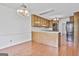 Eat-in kitchen with light wood cabinets, wooden floors, and stainless steel appliances at 100 Walnut Ct, Stockbridge, GA 30281