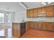Kitchen featuring wood cabinets, peninsula counter, and modern appliances at 100 Walnut Ct, Stockbridge, GA 30281