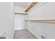 Spacious walk-in closet with wooden shelving and carpeted floor providing ample storage space at 100 Walnut Ct, Stockbridge, GA 30281