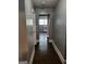 Hallway with view into bright kitchen, and laminate flooring at 3211 Rockview Dr, Lithonia, GA 30038