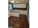 Bright kitchen featuring white cabinets, updated countertops, and laminate flooring at 3211 Rockview Dr, Lithonia, GA 30038