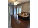 Spacious living room with dark wood flooring, neutral walls, and sliding glass doors at 3211 Rockview Dr, Lithonia, GA 30038