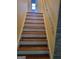 Hardwood staircase with painted risers and a handrail at 3211 Rockview Dr, Lithonia, GA 30038