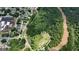 Aerial view showcases a lush park nestled beside the river at 1 Hemlock, Porterdale, GA 30014