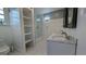 Bright bathroom features double sinks, marble countertop, custom shelving, and a glass-enclosed shower at 1 Hemlock, Porterdale, GA 30014