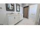 Bathroom with double vanity, marble countertop, unique mirrors, and a modern barn door at 1 Hemlock, Porterdale, GA 30014