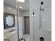 Bathroom features a glass-enclosed shower, white subway tile, modern sink, and a custom mirror at 1 Hemlock, Porterdale, GA 30014