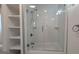 Bright bathroom featuring white subway tiles, built-in shelves, and a glass-enclosed shower at 1 Hemlock, Porterdale, GA 30014