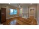 Light-filled bedroom boasts hardwood floors, a window view, and white brick fireplace at 1 Hemlock, Porterdale, GA 30014