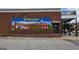 Exterior shot of brick building with a large mural and brown awning at 1 Hemlock, Porterdale, GA 30014