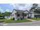 Well-maintained single-story home with a charming front porch, landscaped yard, and nearby neighborhood at 1 Hemlock, Porterdale, GA 30014