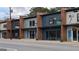 Exterior shot of the storefronts, each with a different paint color at 1 Hemlock, Porterdale, GA 30014
