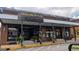 Front view of the storefront, with outside seating and planters at 1 Hemlock, Porterdale, GA 30014
