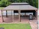 Gazebo with curtains, offering privacy and shade in the backyard oasis at 1 Hemlock, Porterdale, GA 30014