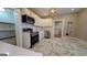 Charming kitchen featuring stainless appliances, white cabinets, and modern hexagon tile flooring at 1 Hemlock, Porterdale, GA 30014