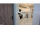 Modern kitchen with white cabinets, stainless steel appliances, and stylish gray and white flooring at 1 Hemlock, Porterdale, GA 30014