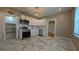 Bright kitchen features stainless steel appliances, white cabinets, and stylish gray and white flooring at 1 Hemlock, Porterdale, GA 30014