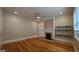 Spacious living room featuring hardwood floors, brick fireplace, and natural light at 1 Hemlock, Porterdale, GA 30014