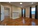 Cozy living room featuring a fireplace, hardwood flooring, and windows with curtains at 1 Hemlock, Porterdale, GA 30014