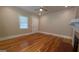 Spacious living room featuring polished hardwood floors and a ceiling fan at 1 Hemlock, Porterdale, GA 30014