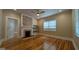 Bright living room with hardwood floors, brick fireplace, and natural light at 1 Hemlock, Porterdale, GA 30014