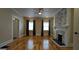 Inviting living room with hardwood floors, a ceiling fan and a stone fireplace at 1 Hemlock, Porterdale, GA 30014