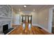 Spacious living room featuring hardwood floors, brick fireplace, and natural light at 1 Hemlock, Porterdale, GA 30014