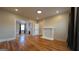 Spacious living room featuring hardwood floors, a fireplace, and an open doorway to a dining area at 1 Hemlock, Porterdale, GA 30014