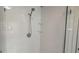 Close-up of a modern glass shower with white subway tiles and dual shelves at 1 Hemlock, Porterdale, GA 30014