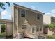 The back exterior features a sliding glass door, vinyl siding, and a small patio area at 162 Watercress Ct, Stockbridge, GA 30281