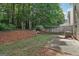 Backyard view showcasing natural landscaping, a wood fence, and an inviting outdoor space at 162 Watercress Ct, Stockbridge, GA 30281