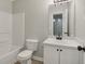 A bathroom featuring a shower-tub combo, toilet, vanity and mirror at 162 Watercress Ct, Stockbridge, GA 30281