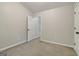 Serene bedroom features neutral walls, plush carpeting, and a private doorway at 162 Watercress Ct, Stockbridge, GA 30281