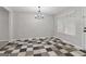 Bright dining room with a chandelier and a black and white checkered tile floor at 162 Watercress Ct, Stockbridge, GA 30281