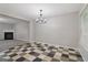 Stylish dining area with checkered floors, a modern chandelier, and an open layout to the living room at 162 Watercress Ct, Stockbridge, GA 30281