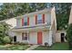 Charming two-story home with red shutters and front door, set in a lush, green environment at 162 Watercress Ct, Stockbridge, GA 30281