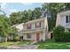 Inviting two-story home with a manicured lawn, red shutters and door, and a driveway at 162 Watercress Ct, Stockbridge, GA 30281