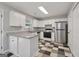 Updated kitchen featuring white cabinets, stainless steel appliances, and granite countertops at 162 Watercress Ct, Stockbridge, GA 30281