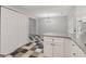 Open concept kitchen with white cabinets, granite countertops, and checkerboard flooring, with view to dining area at 162 Watercress Ct, Stockbridge, GA 30281