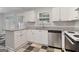 Modern kitchen featuring stainless steel appliances, granite countertops, and white cabinets at 162 Watercress Ct, Stockbridge, GA 30281