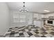 Bright kitchen featuring checkerboard floors, white cabinets, granite countertops, and stainless steel appliances at 162 Watercress Ct, Stockbridge, GA 30281