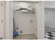 Practical laundry area with shelving, washer/dryer hookups, and ample storage space at 162 Watercress Ct, Stockbridge, GA 30281