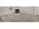 Cozy living room with a fireplace, neutral carpeting, and an open view to a dining space at 162 Watercress Ct, Stockbridge, GA 30281