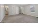 Spacious living area boasts neutral walls, carpet flooring, and access to the bathroom and entryway at 162 Watercress Ct, Stockbridge, GA 30281