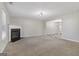 Spacious living room with plush carpeting, fireplace, and an open layout to the dining area at 162 Watercress Ct, Stockbridge, GA 30281