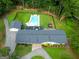 Aerial view of home with fenced pool area, stone patio, and long paved driveway at 396 Ebenezer Rd, Fayetteville, GA 30215