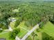 Expansive view of the wooded property including a home with a long driveway, yard, and pool at 396 Ebenezer Rd, Fayetteville, GA 30215